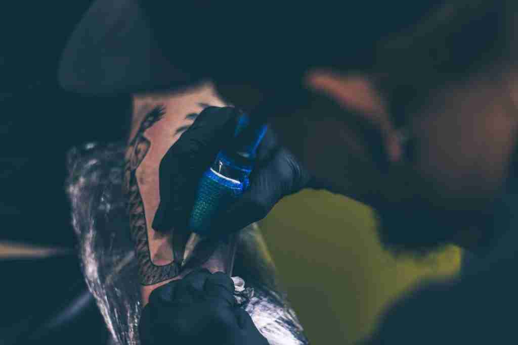 24 Fun Facts About Tattoos: Get Ink-spired 3 Man Tattooing Person on Arm - Fun Facts About Tattoos