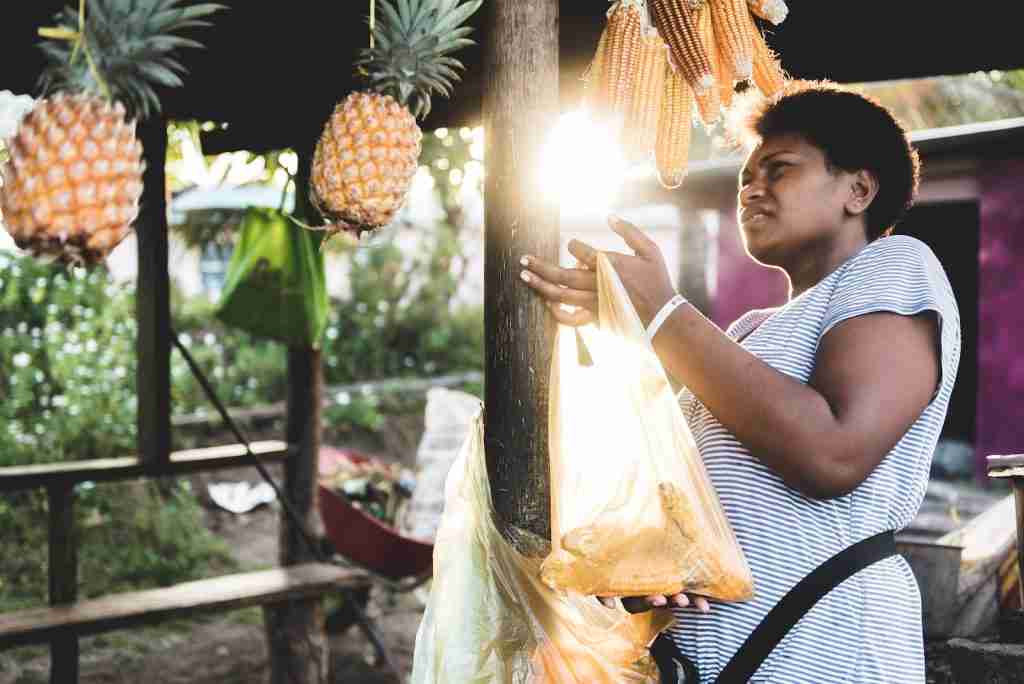 26 Fun Facts About Fiji That Will Make You Pack Your Bags 1 woman holding yellow plastic bag near pineapple fruits