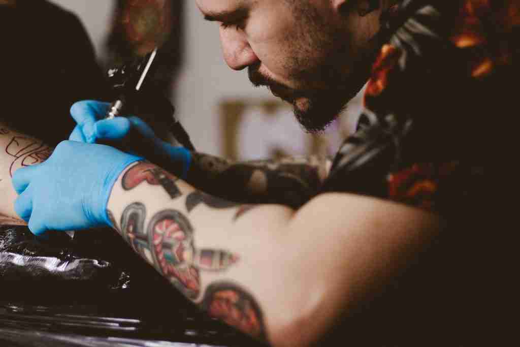 24 Fun Facts About Tattoos: Get Ink-spired 1 man doing tattoo on person's arm