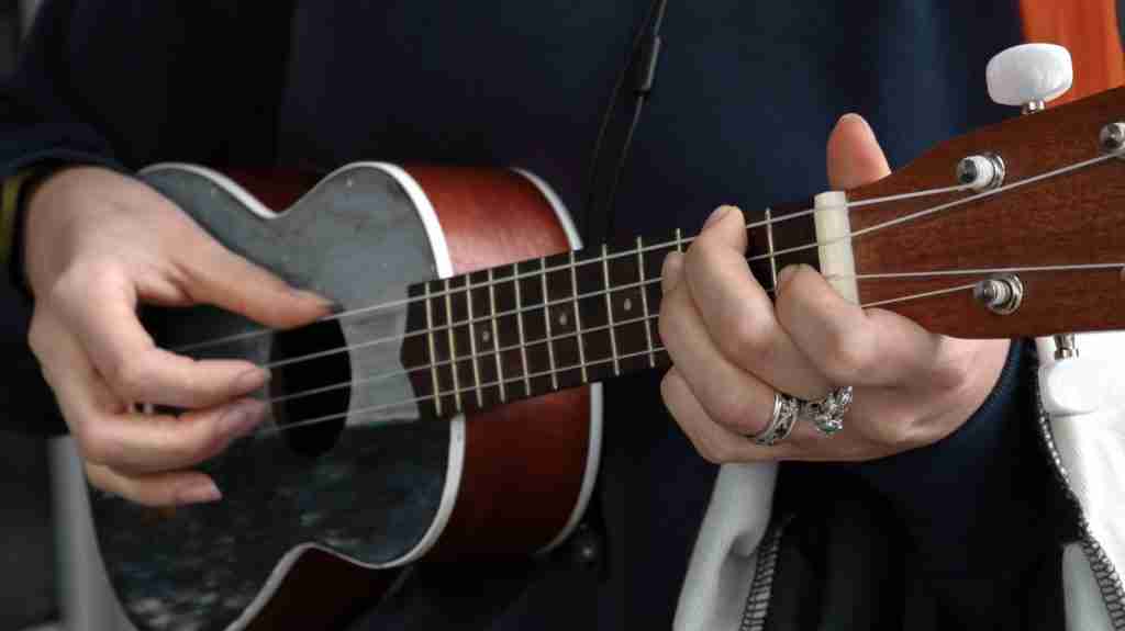 23 Fun Facts About the Ukulele You Might Not Know 1 person playing red Ukulele.