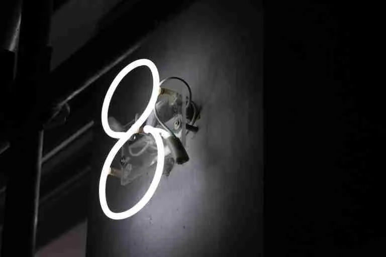 a close up of a light on a wall with number 8 written.