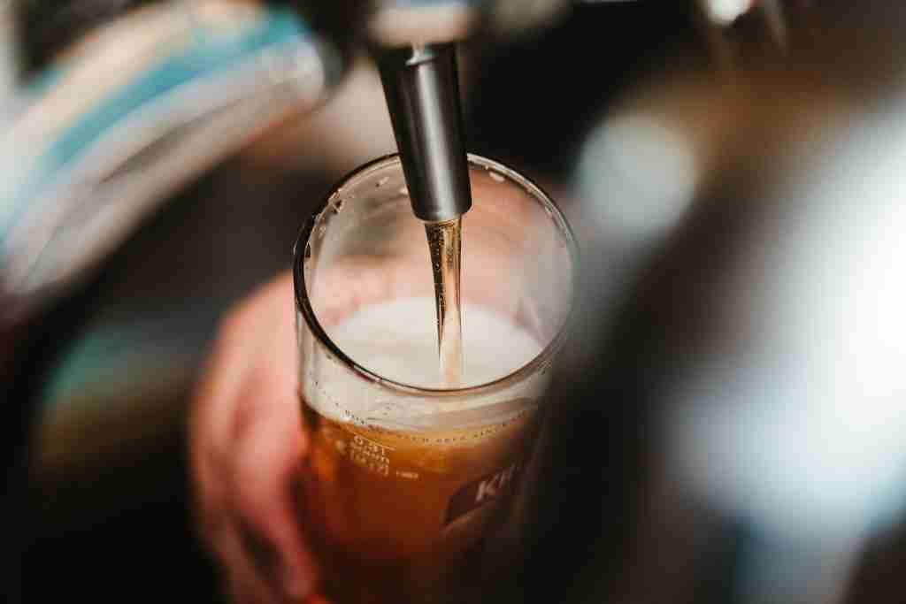 20 Fun Facts About Beer: The Brew-tiful Trivia You Never Knew 2 person filling clear glass with liquid