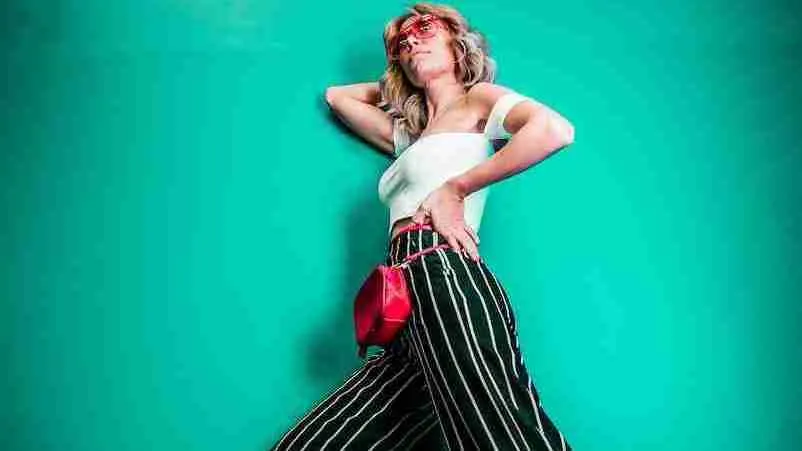 25 Interesting Facts About Y2K Fashion (Unveiled) 3 posing woman in white sleeveless top with baggy trousers part of Y2K fashion