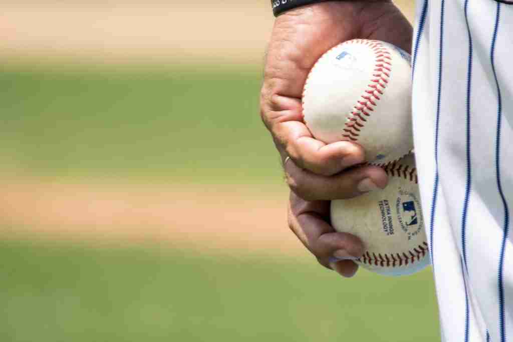 24 Fun Facts About Baseball That Will Knock Your Socks Off 2 player holding two white baseballs