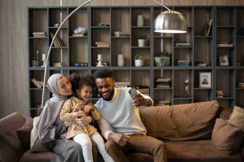 26 Fun Facts About Australia | Queensland's Quirky Quests 4 Delighted multiethnic family taking selfie sitting on couch