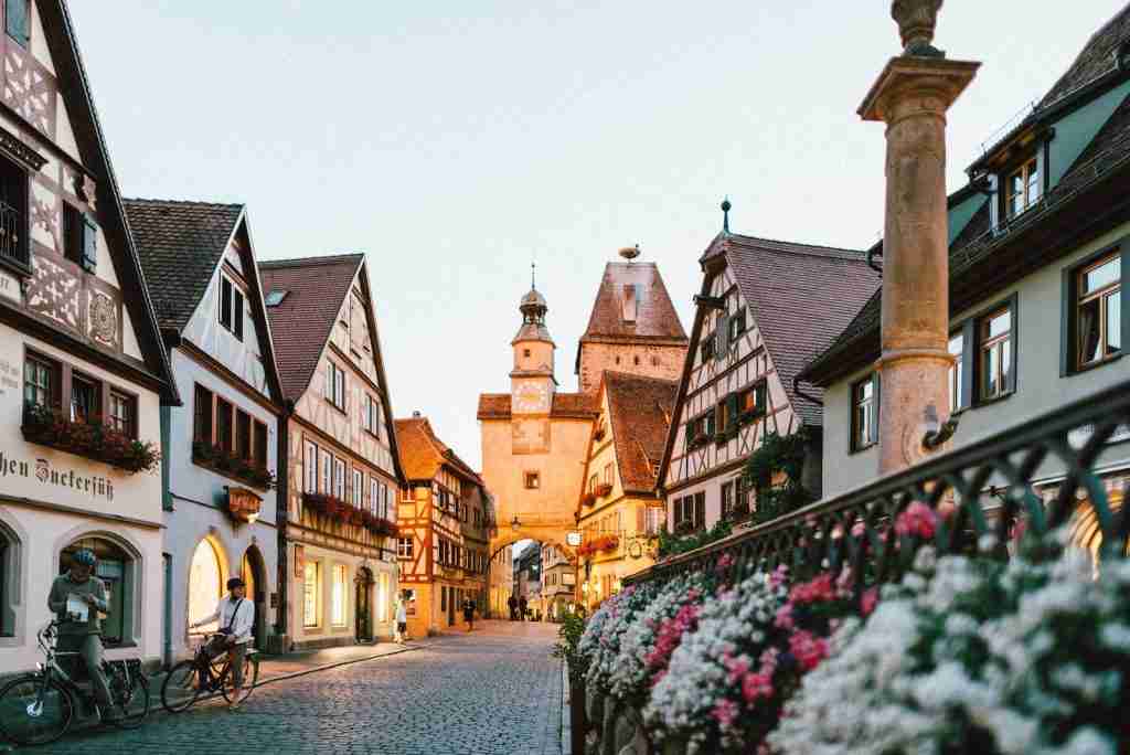25 Fun Facts About Germany | From Fairy Tales to Fanta 4 white and pink petaled flowers on metal fence near concrete houses and tower at daytime
