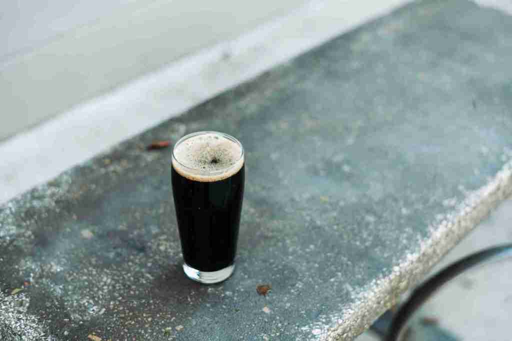 25 Fun Facts About Oysters: The Untold Story of Oysters 5 a glass of beer sitting on top of a cement bench