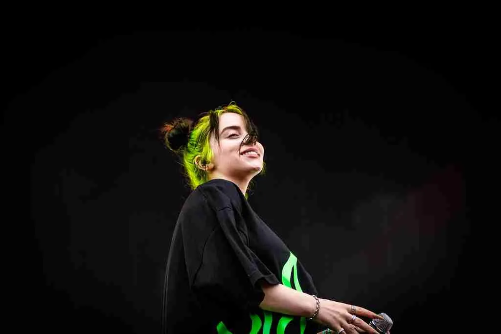 Fun Facts About Billie Eilish: Music, Style & Career Trivia 3 Billie Eilish poses in a portrait with a black background, capturing the essence of fun facts about Billie Eilish.