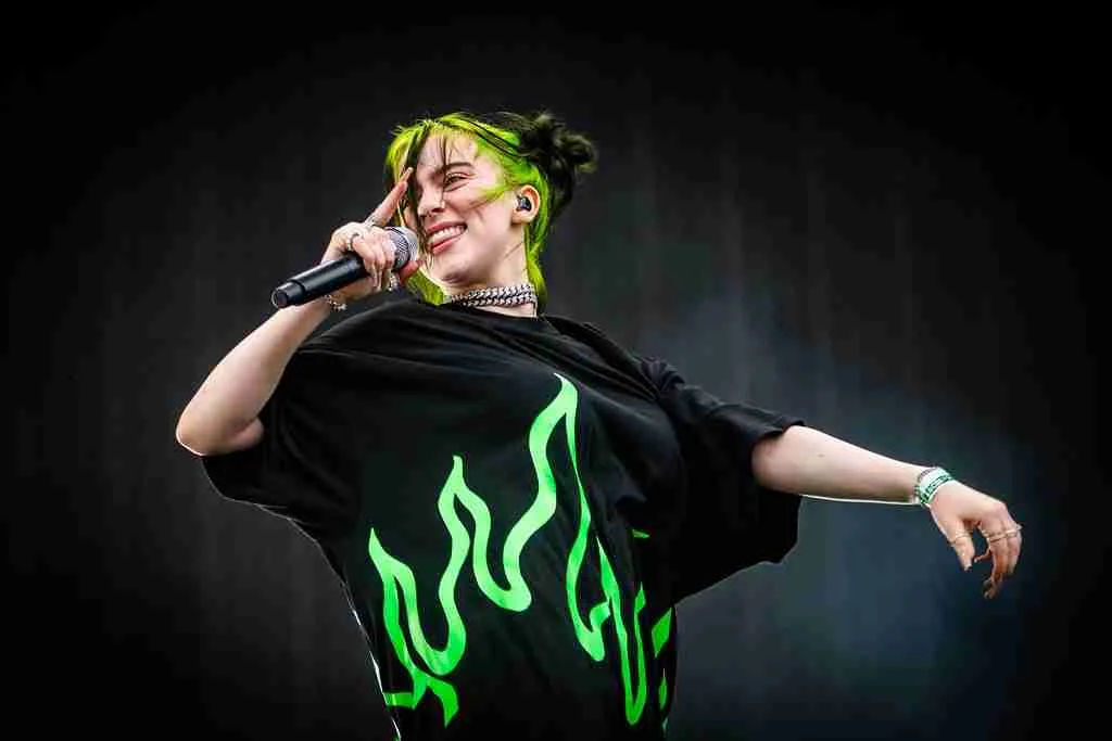 Fun Facts About Billie Eilish: Music, Style & Career Trivia 1 Billie Eilish holding a mic