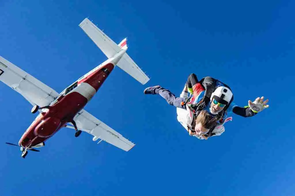 26 Fun Facts About Skydiving | You Never Knew 2 white and red airplane in mid air during daytime