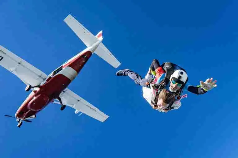 white and red airplane in mid air during daytime