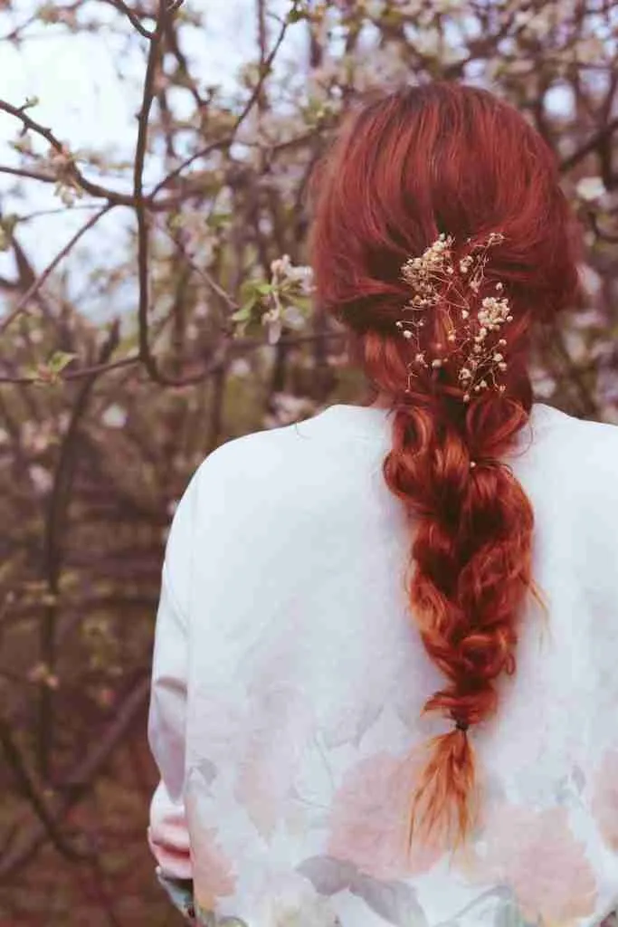 woman facing pink flowering tree- fun facts about colors