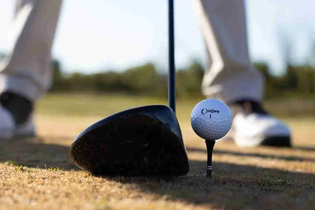 A white golf ball on a black golf club, elegantly highlighting the facts about golf and its intricate details.