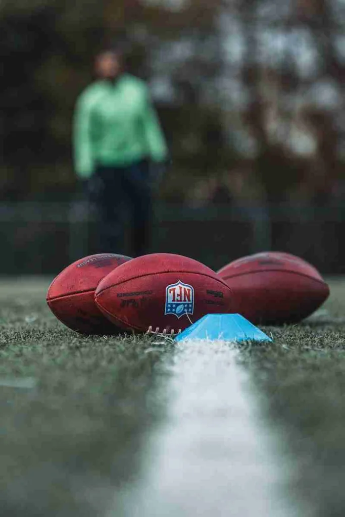 24 Fun Facts About the NFL | Legends and Lore Explained 3 person in blue jacket holding brown football