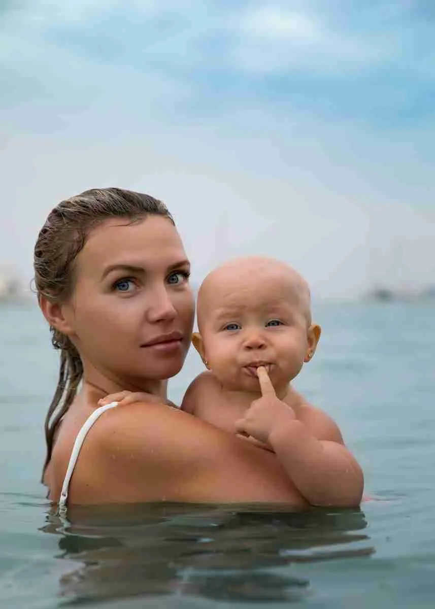 22 Fun Facts About Newborns | Eye-Opening Details 2 a person holding a baby in the water