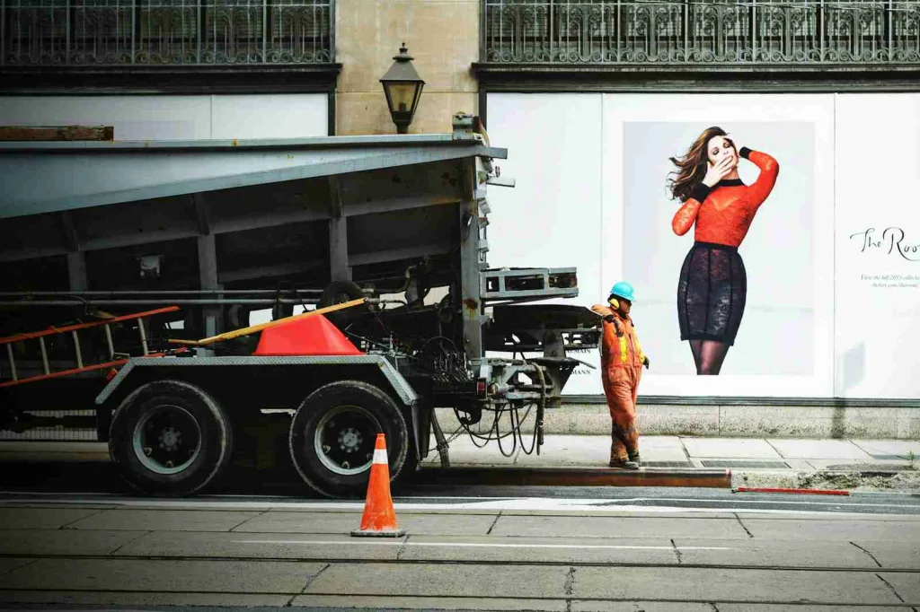 Person wearing orange suit while leaning on truck - Fun Facts About the Color Orange.