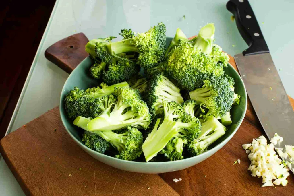 23 Fun Facts About Broccoli: The Ultimate Superfood 2 green broccoli on brown wooden chopping board showcasing fun facts about Broccoli