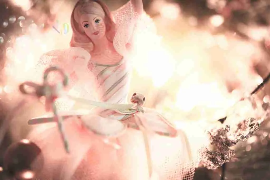girl in pink dress with white wings
