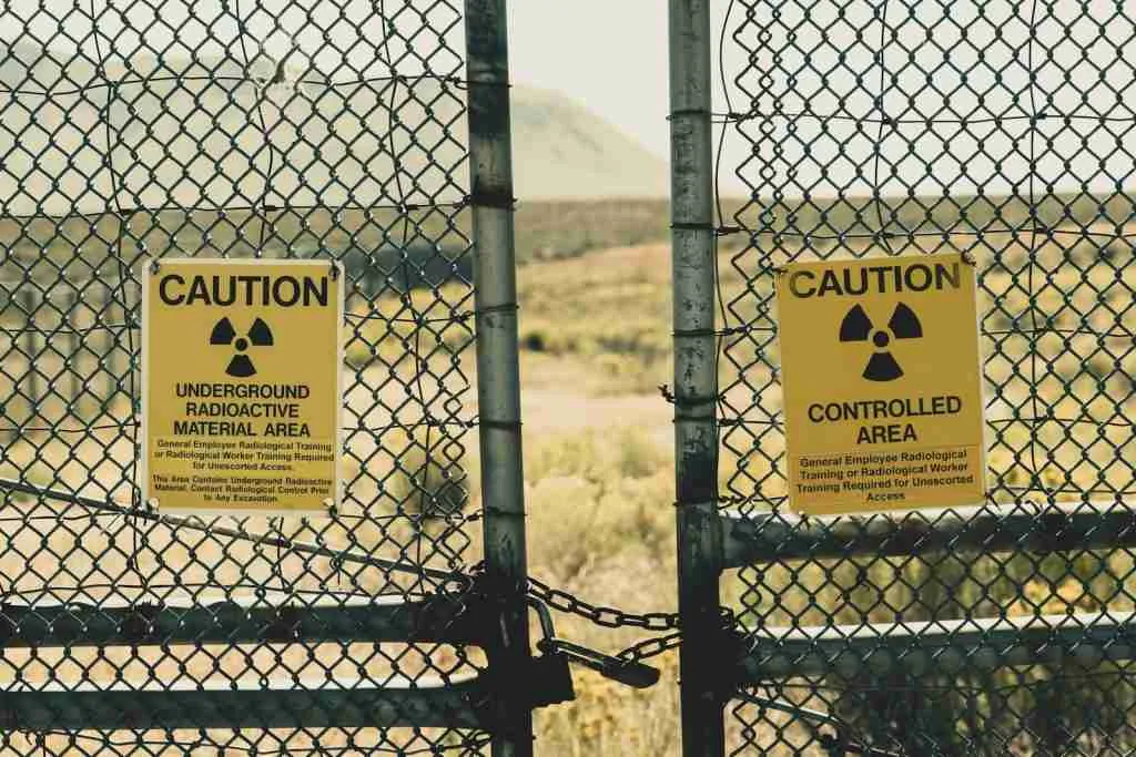 A couple of signs on a fence providing interesting facts about nuclear energy.